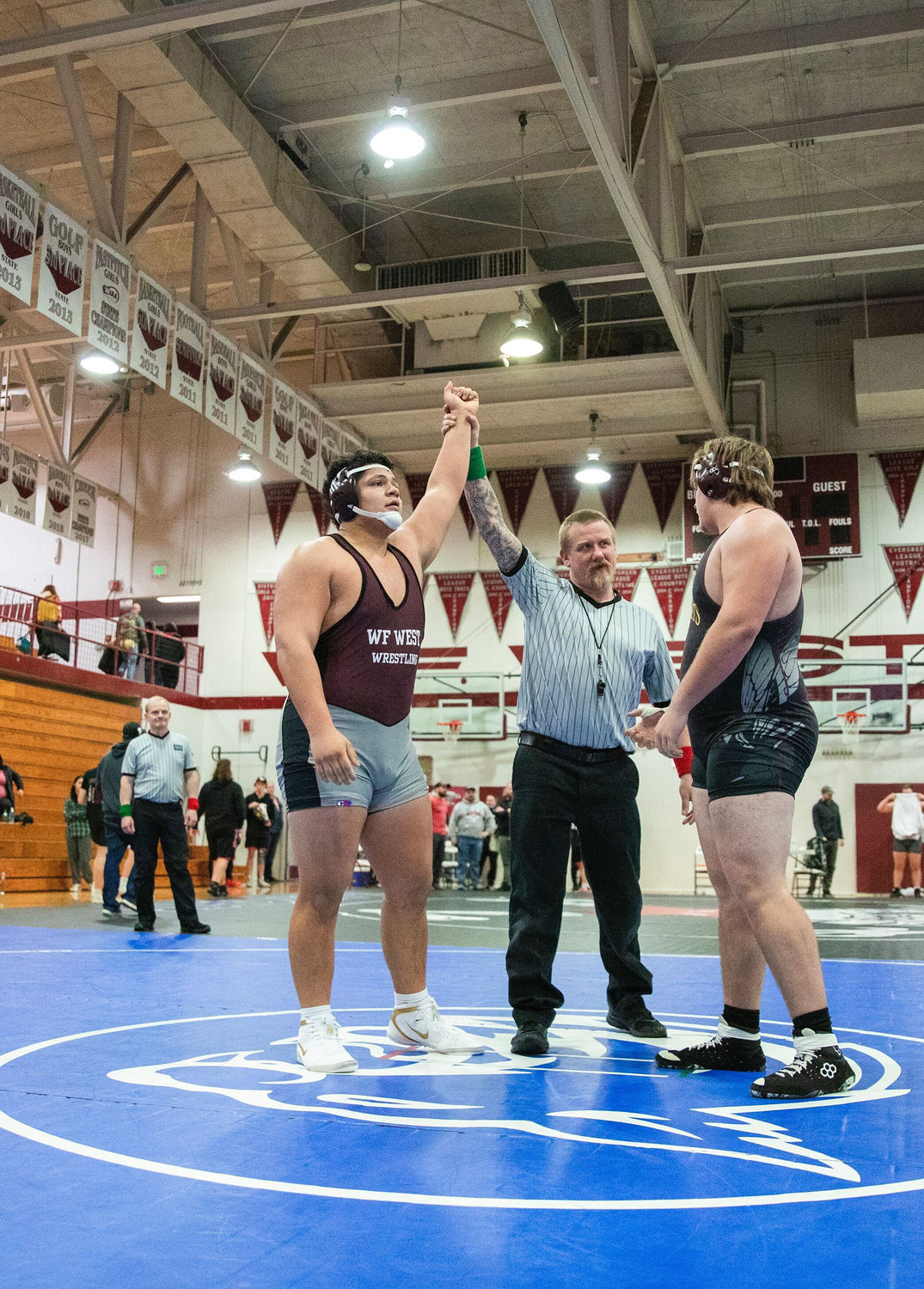 W.F. West senior Daniel Matagi defeats Zeke Luchi of Enumclaw at 285 pounds during the Bearcat Invitational and his last home meet in Chehalis Saturday night.